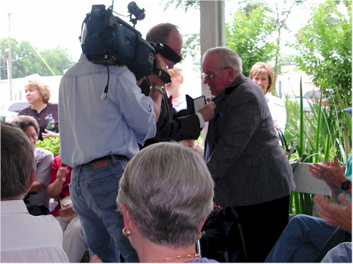 Mr. Ed J. Reitsma pins medal on W. T. Block